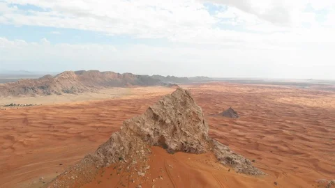 Aerial rock in desert with drone with clouds Stock Footage