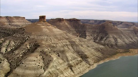 Aerial of rock mountain and structures on the shore, Flight Around North Chimney Stock Footage 109472888