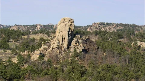 Aerial of rock structure surrounded with forest trees, Rock formation jutting Vidéo 109470569