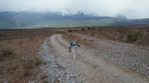 Aerial rocky river plain and storm clouds near Lijiang Yunnan China Stock Footage 337861484