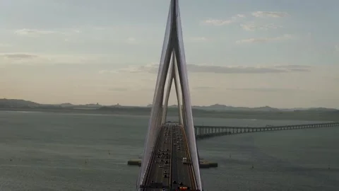 Aerial Roll Shot Flying Toward Overlapping Incheon Bridge Pylons at Sunset Video stock 345709106