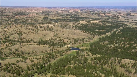 Aerial of rolling hills covered with trees, Red Rocks In Crow Indian Reservation Stock Footage 109465327