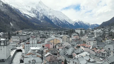 Aerial of rooftops of Chamonix ski resort with snowy french alps on horizon Stock Footage 121595708