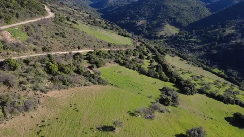 Aerial rotating panoramic view of steep mountain slope and farmland Stock Footage 337459378