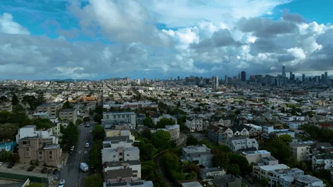 Aerial rotating pull back drone shot of San Francisco hills and skyline Stock Footage 335937681