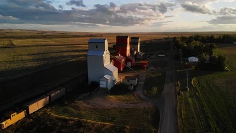 Aerial rotating shot of three Grain Elevators surrounded by agricultural Video stock 171579918
