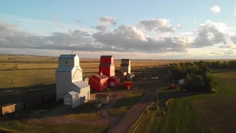 Aerial rotating shot of three Grain Elevators surrounded by agricultural Video stock 171580392