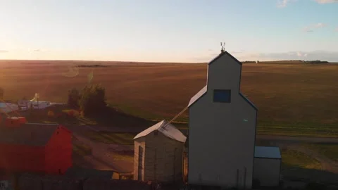 Aerial rotating shot of three Grain Elevators with houses of farmers on Video stock 171581237