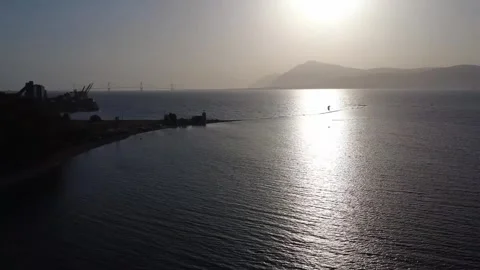 Aerial rotating sunset harbor and calm sea with kite surf in Greece Stockbeeldmateriaal 337047817