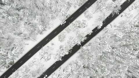 Aerial rotating top-down view of snowed up divided highway on cloudy winter day 스톡 동영상 262700426