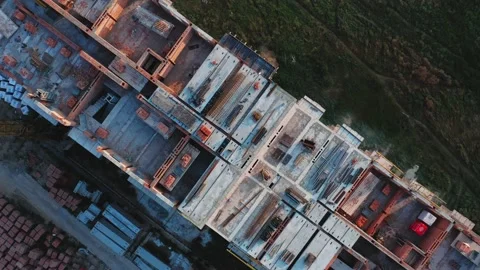 Aerial rotating top view of the construction of a residential building at sunset Stock Footage 158872002