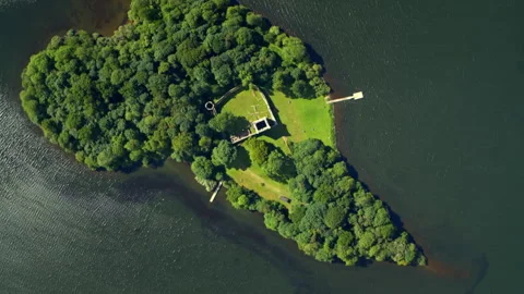 Aerial rotating view of ancient castle ruins on a lake island Video stock 336795283