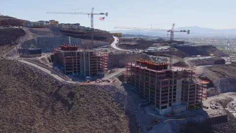 Aerial Rotating View Hillside Construction Cranes in Henderson Nevada Stock-Footage 333722715