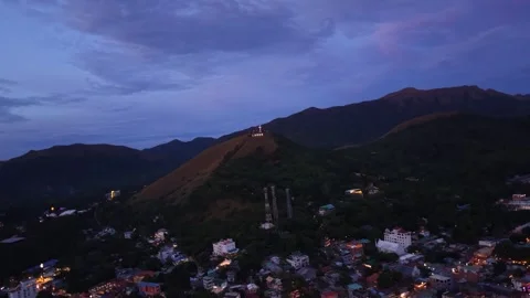 Aerial rotating view of Mount Tapyas cross at dusk, Coron town, Philippines Stock Footage 325794507