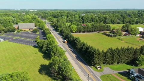Aerial Rotation Over Suburban Intersection and Tree‑Lined Roads Stock Footage 336699160