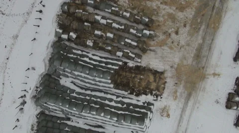 AERIAL - Round Bale Hay Stacks With Snow Stock-Footage 35595089