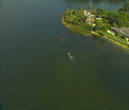 Aerial rowing practice on lake Stock Footage 22980497
