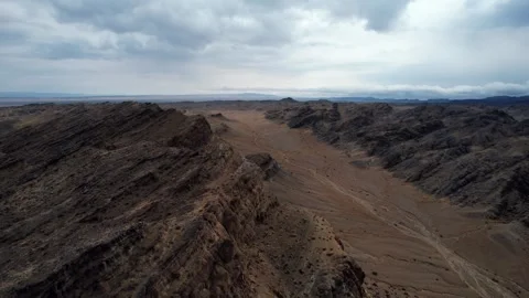 Aerial Of Rugged Strata Patterns In Mongolian Gobi, Noyon Uul, Mongolia Stock Footage 333547082