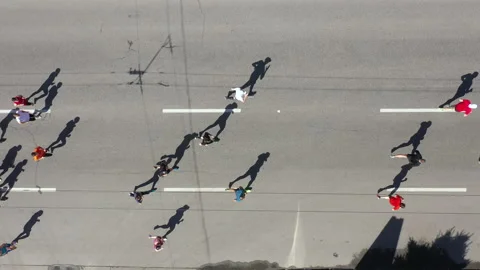 Aerial of runners and physically challenged athletes taking part in marathon Stock Footage 154360500