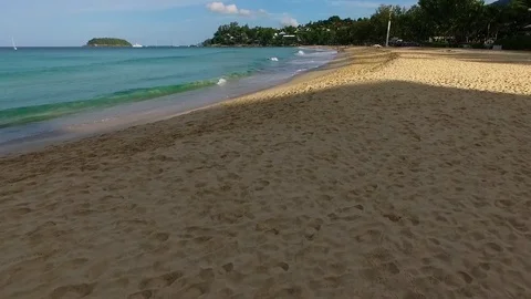 Aerial: Running with waves on the beach. Stock Footage 69731107