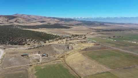 Aerial rural community farm fields sheep mountain valley 4K Stock Footage 142173474