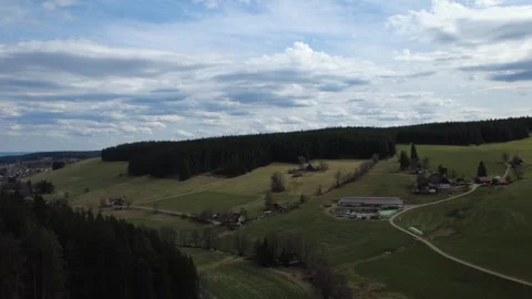 Aerial rural landscape with hills fields and forest under blue sky Stock Footage 332947491