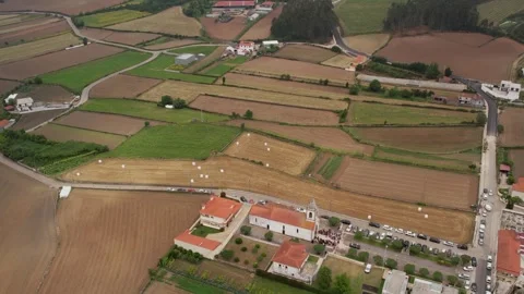 Aerial rural landscape of Minho with patchwork fields and village church Stock Footage 311418711