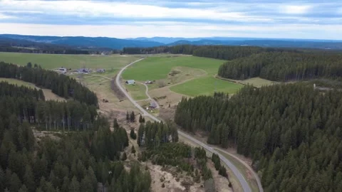 Aerial rural landscape in spring, fields hills and village Germany Stock Footage 332441663
