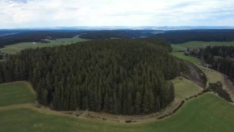 Aerial rural landscape in spring, fields hills and village Germany Stock Footage 332441707