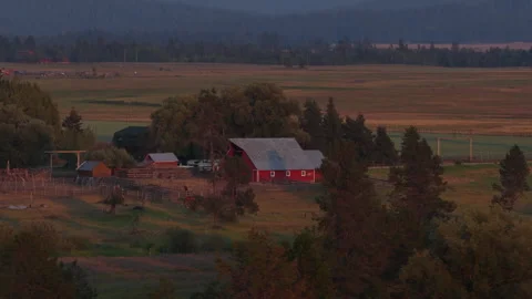 Aerial of rural ranch complex and fields in Donnelly Idaho with red barn Stock Footage 341522390