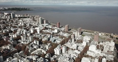 Aerial sails high over the rooftops of Montevideo towards the Rio Plata Stock-Footage 92171992
