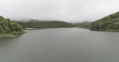 Aerial sails low over the Fresh Water Lake in Dominica on a cloudy day Stock-Footage 78310171