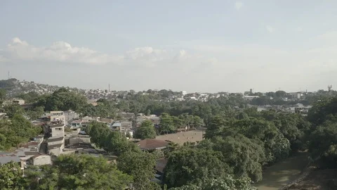 Aerial sails low over trees towards a soccer game in Florencia, Colombia Vídeos de archivo 104776108