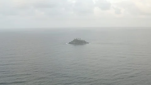 Aerial sails out over open Caribbean sea past tiny island near Capurgana Stock Footage 107787390