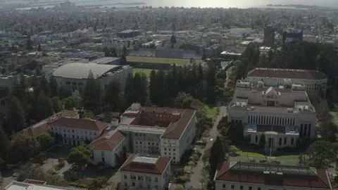 Aerial sails over the Cal Berkeley campus towards a baseball field on sunny day Stock-Footage 153495933