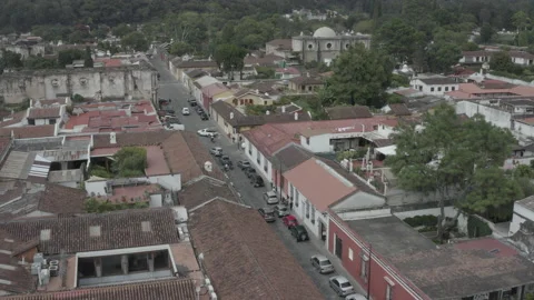 Aerial sails over red brick rooftops and colonial streets of Antigua, Guatemala Stock-Footage 167933960