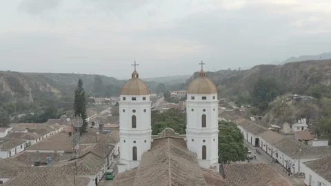 Aerial sails through the steeples of Playa de Belen's church from the back 스톡 동영상 127949556