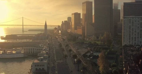 Aerial of San Francisco Ferry Building, bay bridge, Embarcadero & city at Stock Footage