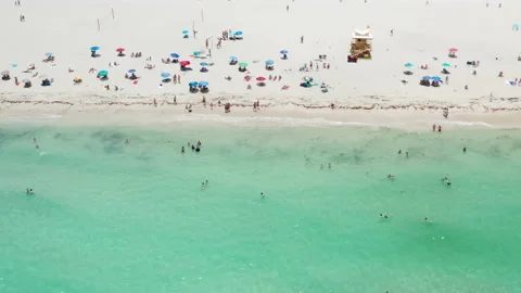 Aerial sand beach, people at tropical beach celebrating summer vacation 4K Miami Stock Footage 149995995