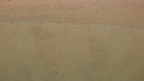 Aerial of sandy beach. Top view of calm and lazy transparent sea waves Stock Footage 125641677