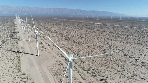 Aerial scene wind field full of aligned wind turbines. Sustainable green energy Stockbeeldmateriaal 103368441