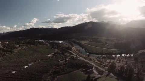 Aerial: Scenic Rural Valley with Farmlands and Rivers on Bright Afternoon Stock Footage