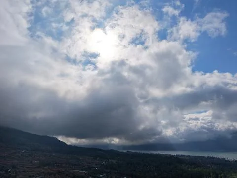 Aerial scenic view of dramatic clouds and sunbeams over Lake Batur Stock Photos