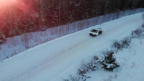 AERIAL: Scenic view of van speeding through white snow covered highway trough Stock Footage 130148679