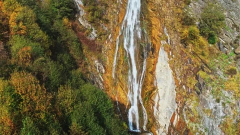 Aerial scenic waterfall in colourful fall forest, autumn hiking in caucasus Stock Footage 305604264