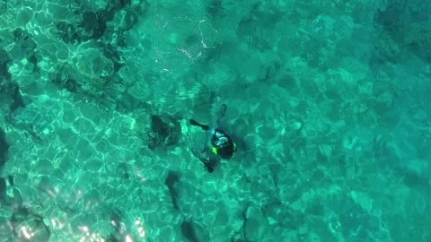 Aerial scuba diving training above rocky reef - Ocean Practice and Snorkel Area Stock Footage 339753107