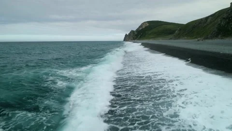 Aerial sea waves hitting pebble beach dramatic nature landscape Epic cliffs rock Stock Footage 145767853