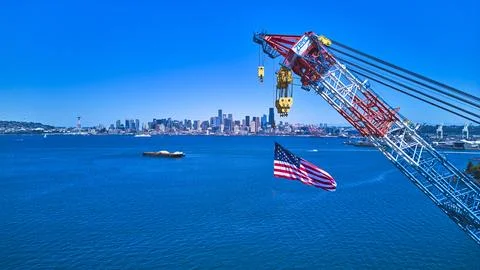 Aerial Seattle Skyline American Flag and Industrial Crane Over Puget Sound Stock Photos