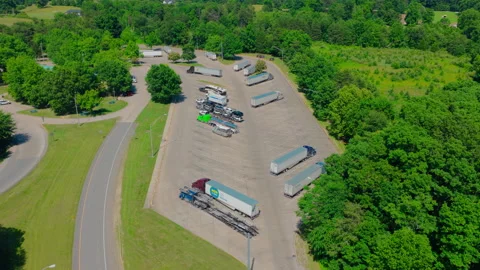 Aerial of semi trailers parked at a highway rest stop for truck drivers Stock Footage 345890970