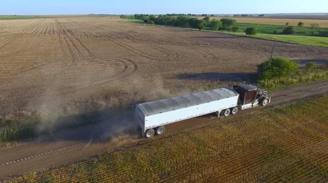 Aerial of Semi Truck Loaded with Grain Leaving the Field during Harvest (Kansas Stock Footage